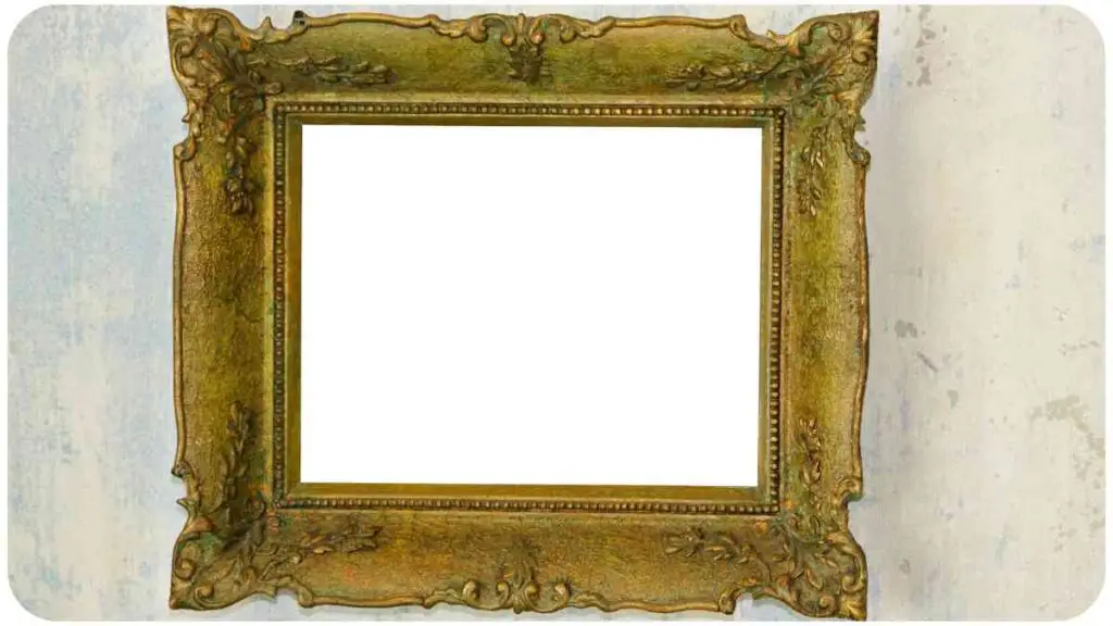 an ornate gold frame hanging on a wall