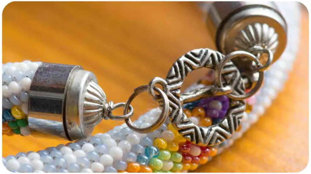 a close up of a beaded bracelet with a silver clasp