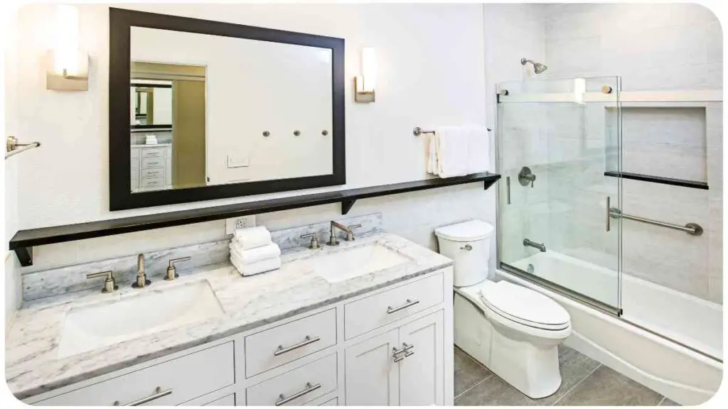 a bathroom with two sinks, a toilet and a shower