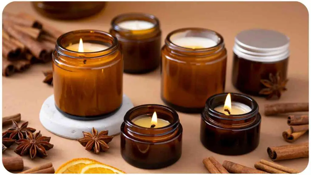 candles in glass jars with cinnamon sticks and orange slices