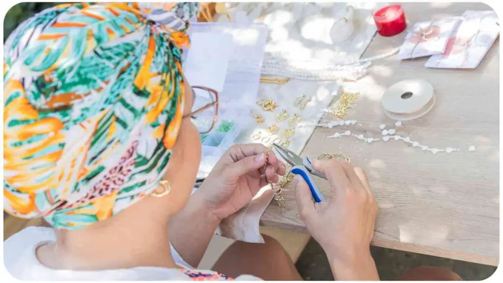 a person wearing a headscarf is working on some jewelry