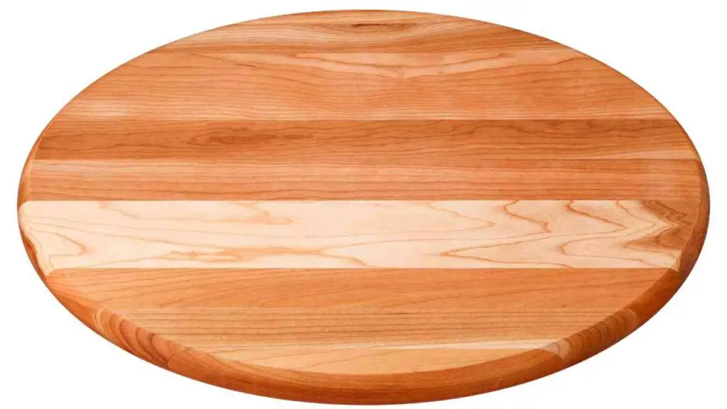 a round wooden cutting board on a white background