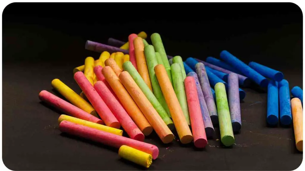 a pile of colored chalk sticks on a black background